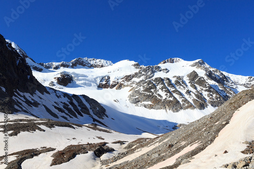 Mountain snow panorama with glacier Sexegertenferner and blue sky in Tyrol Alps, Austria