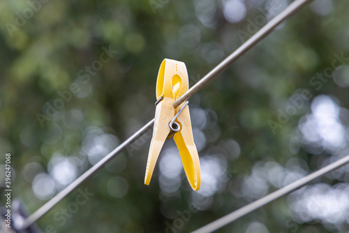 Yellow clothes peg on a clothesline