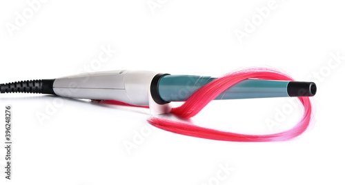 Curling iron with hair strand on white background