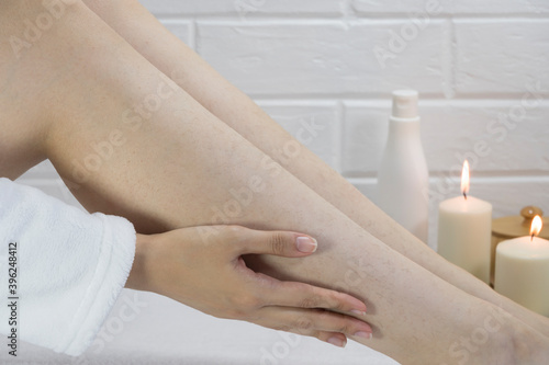 Hair on the legs of women. Skin care, body. Preparing legs for the procedure of hair removal. Body positive, self-acceptance, feminism. Apply the cream, massage. Strawberry legs, keratosis. Relaxation