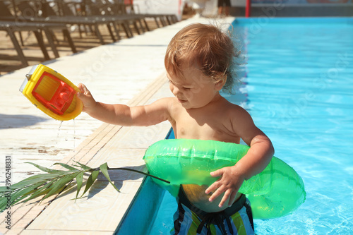 Cute baby boy with inflatab...
