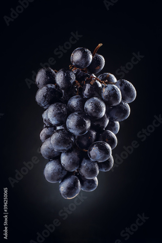 Dark grapes on a black background