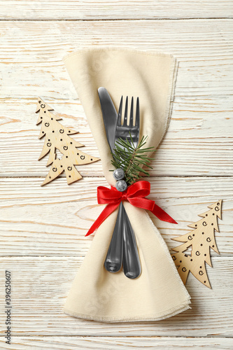 Napkin with New year cutlery on wooden background
