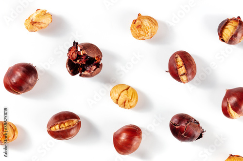 Roasted chestnuts, overhead flat lay shot on a white background