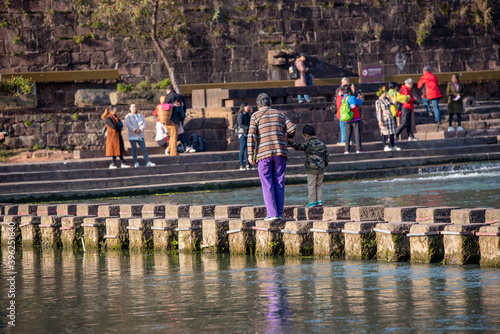 Tourists walking along Phoenix Ancient Town (Fenghuang County). Awesome view of scenic old street. Fenghuang is a popular tourist destination of Asia.