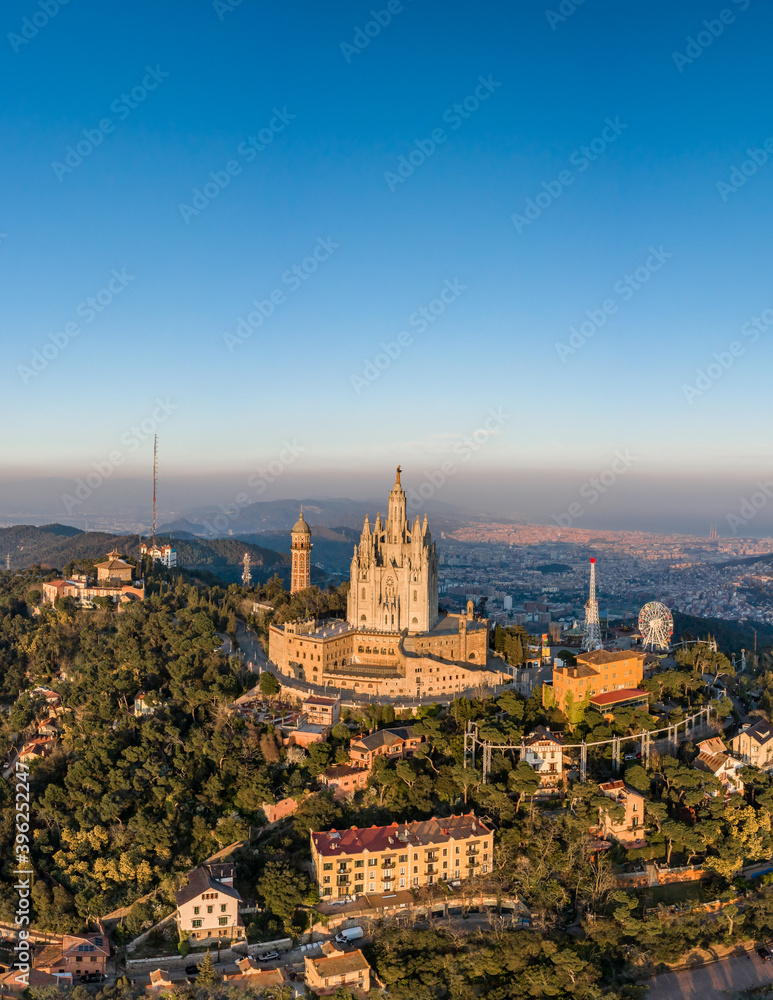 Aerial drone view of Basilica Sacred Heart on Mount Tibidabo near barcelona during sunset golden hour