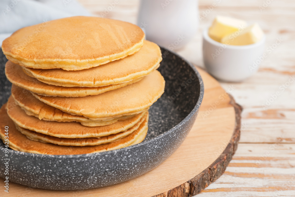 Frying pan with tasty banana pancakes on table Frying pan with tasty banana pancakes on table