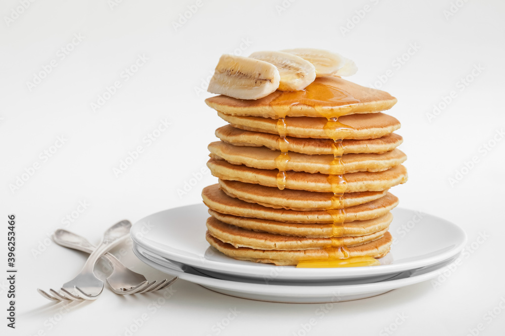 Tasty banana pancakes on white background Tasty banana pancakes on white background