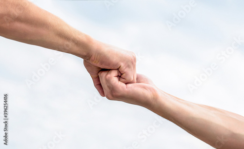 Rescue, helping gesture or hands. Two hands, helping arm of a friend, teamwork. Helping hand outstretched. Friendly handshake, friends greeting, teamwork, friendship © Yevhen