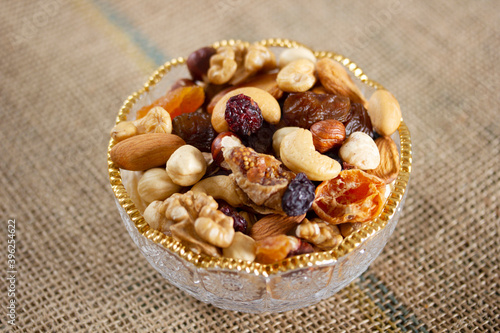 Mixed nuts in a glass plate. Healthy and natural nutrition .Cashew, Almond,, Hazelnut,, Fig,, Walnut,, Apricot,, Raisin,, Blueberry.
