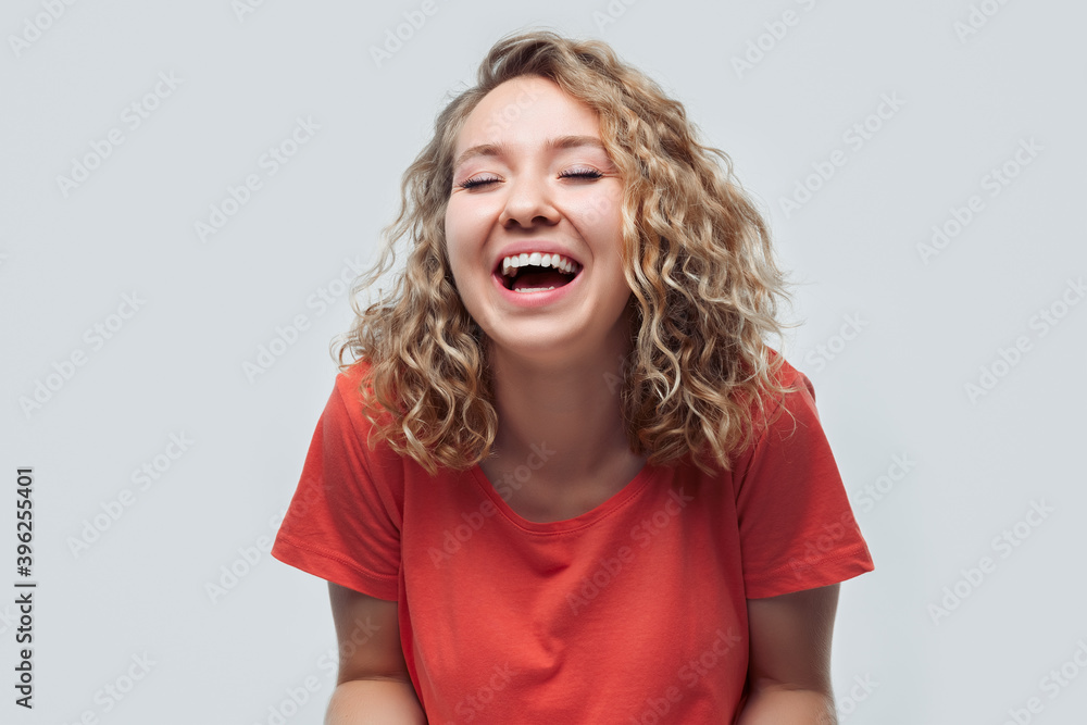 Image of young happy woman smiling and looking at camera, wearing in casual clothes. Facial expression concept Image of young happy woman smiling and looking at camera, wearing in casual clothes. Facial expression concept