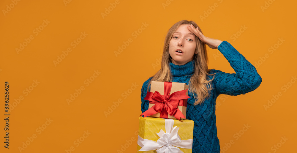 Charming young woman holding a lot of gift boxes. Studio shot, yellow background. New Year, Birthday, Holiday concept Charming young woman holding a lot of gift boxes. Studio shot, yellow background. New Year, Birthday, Holiday concept