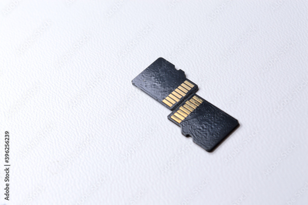 two micro sd cards on a white plastic background. close-up.