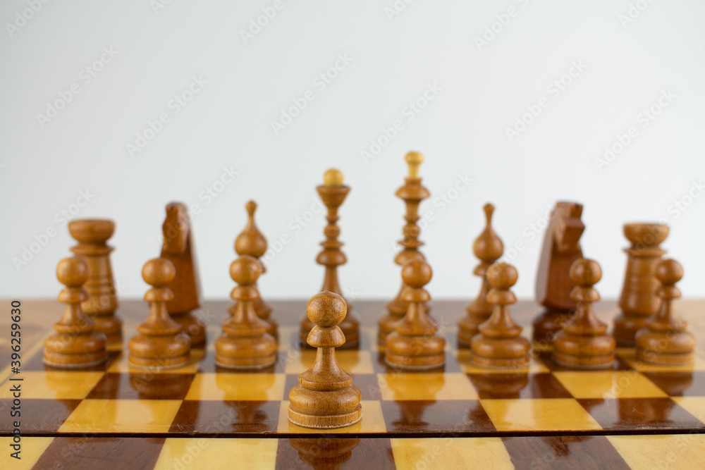 chessboard made of wooden pieces on white