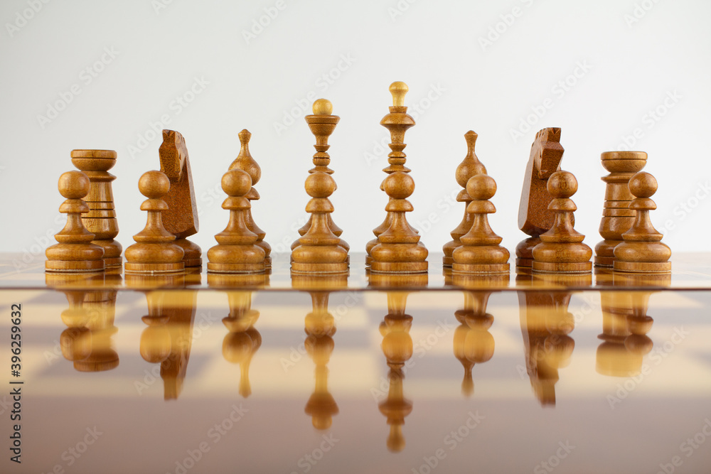 chessboard made of wooden pieces on white chessboard made of wooden pieces on white