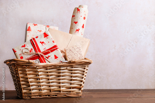 Wrapped Christmas gifts in a storage basket