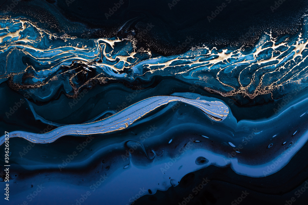Fluid Art. Liquid Metallic Gold in abstract blue wave. Marble effect background or texture