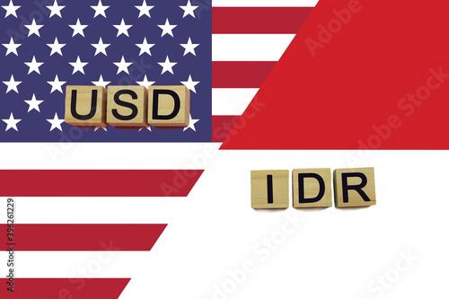 USA and Indonesia currencies codes on national flags background
