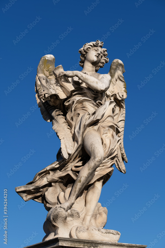 Angel with the Superscription statue on Ponte Sant Angelo bridge in Rome, Italy. Marble sculpture from 17th century, design of Gian Lorenzo Bernini