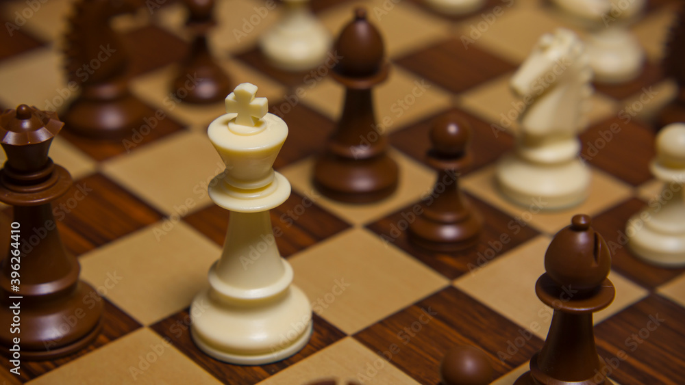 Chess game pieces on chess board. Checkmate. The featured king. Chess game pieces on chess board. Checkmate. The featured king.