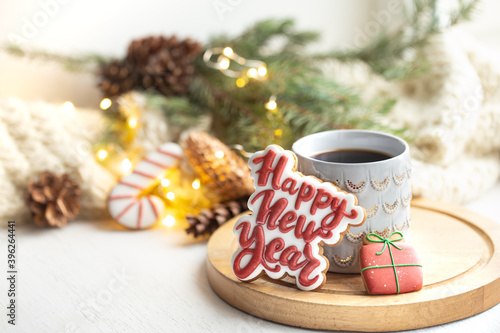 Christmas composition with beautiful cup and gingerbread cookies with happy new year wishes.