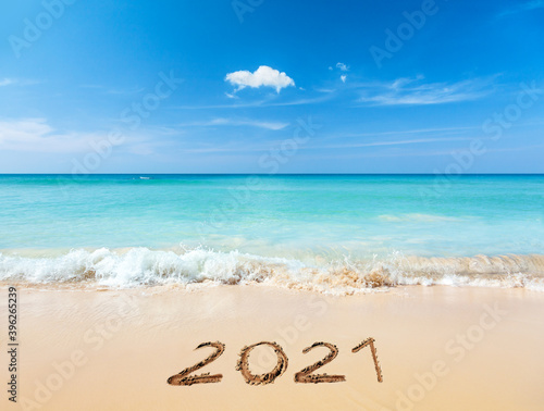 2021 written on sandy beach © adisa