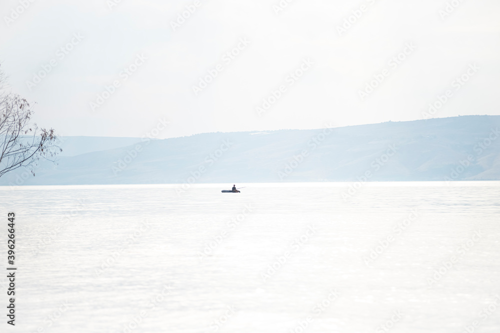 Fototapeta premium Fishing with a fishing rod in the center of the Sea of Galilee. Lake Tiberias, Kinneret, Kinnereth. High quality photo