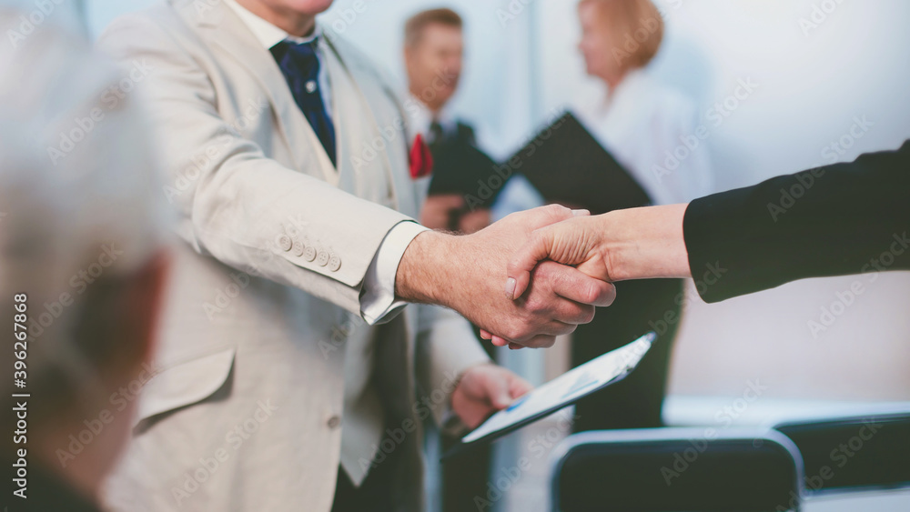 confident businessman shaking hands with his business partner.