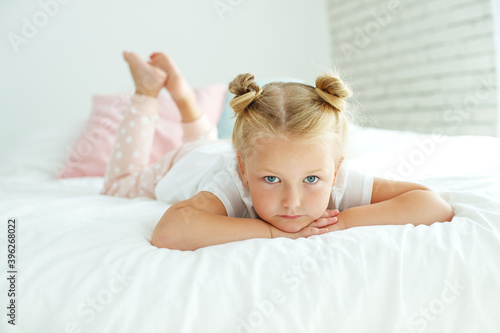 Wallpaper Mural Nice baby girl enjoys a sunny morning. Good morning at home. The girl wakes up from sleep. High quality photo. Torontodigital.ca