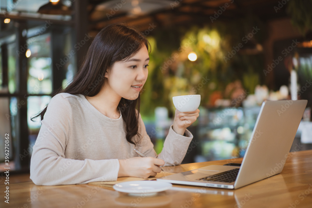 Asian beautiful working woman doing her work and drink in the coffee shop or cafe. Asian beautiful working woman doing her work and drink in the coffee shop or cafe.
