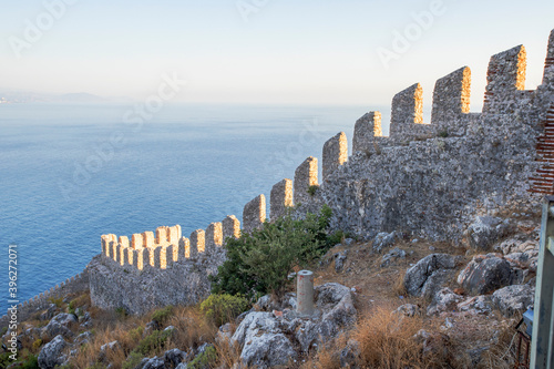 Elements of an ancient fortress. ancient city. Fortress on the rocks. Ruined walls of a medieval castle on the mountain. photo