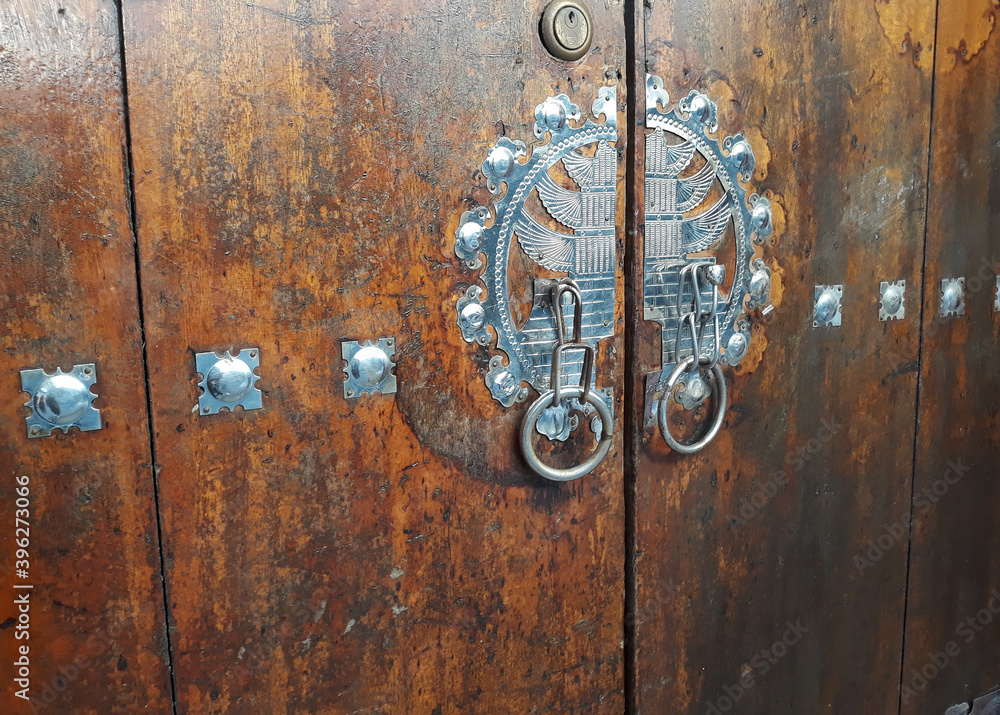 Antique traditional Korea metal doorknob on wooden door