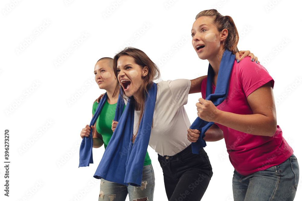 Teamwork. Female soccer fans cheering for favourite team with bright emotions isolated on white studio background. Beautiful caucasian women look excited, supporting. Concept of sport, fun, support. Teamwork. Female soccer fans cheering for favourite team with bright emotions isolated on white studio background. Beautiful caucasian women look excited, supporting. Concept of sport, fun, support.