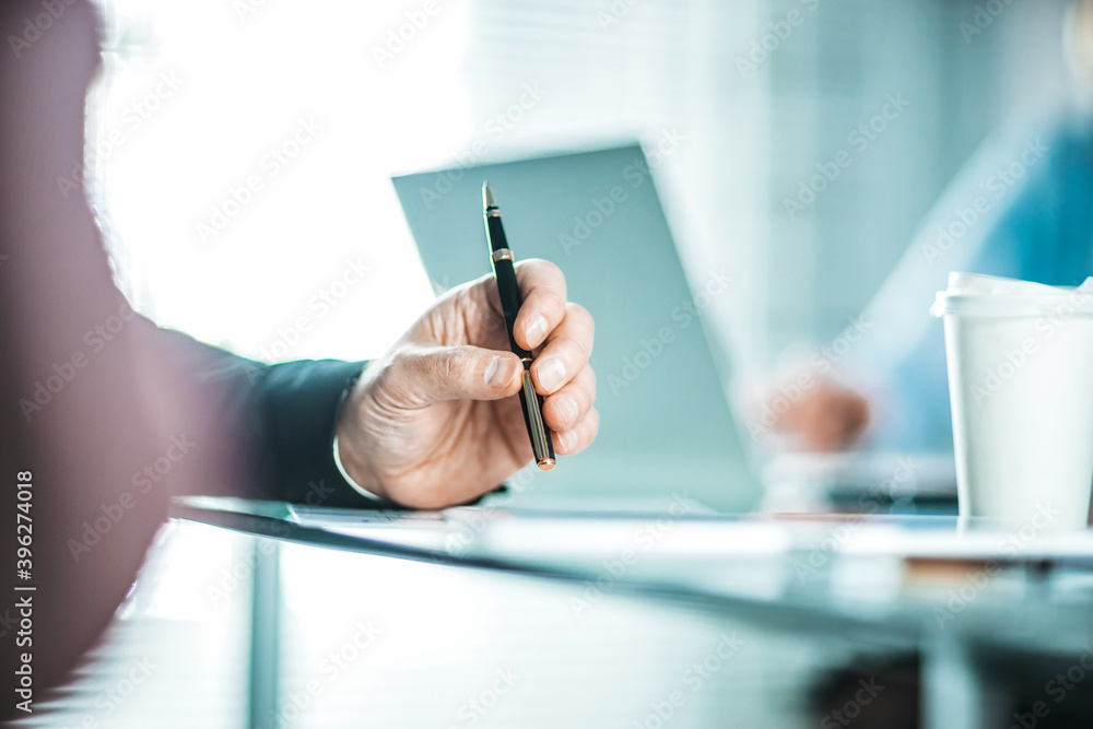 background image of a businessman sitting near the desktop. background image of a businessman sitting near the desktop.