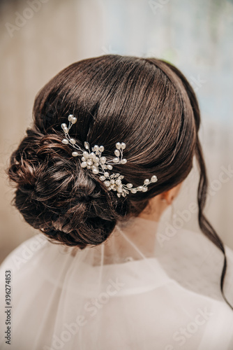 Wedding hairstyle bun with barrette on dark hair