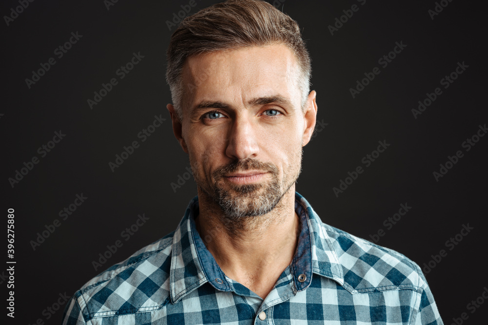 Masculine confident man posing and looking at camera Masculine confident man posing and looking at camera