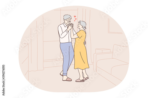 Senior elderly couple living happy active lifestyle concept. Mature aged couple pensioners woman and man standing hugging and feeling love to each other at home. Retiree, pensioner happiness