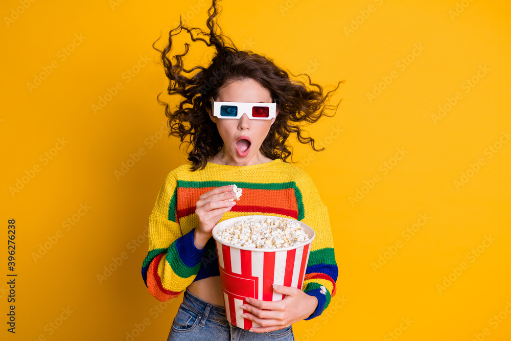Photo of pretty shocked lady hold popcorn bucket watch movie thriller wear spectacles striped sweater isolated yellow background Photo of pretty shocked lady hold popcorn bucket watch movie thriller wear spectacles striped sweater isolated yellow background