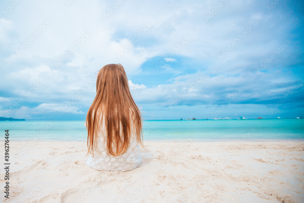 Adorable little girl at beach during summer vacation