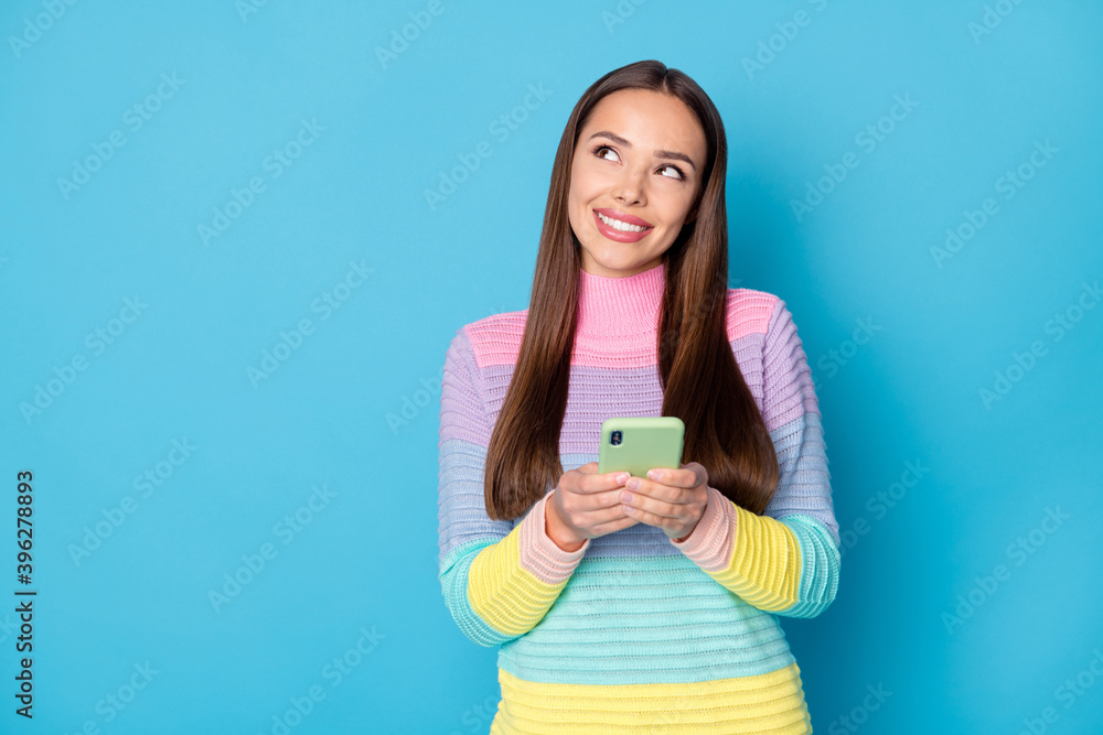 Portrait of lovely dreamy creative cheerful girl using gadget creating comment smm copy space isolated on bright blue color background Portrait of lovely dreamy creative cheerful girl using gadget creating comment smm copy space isolated on bright blue color background