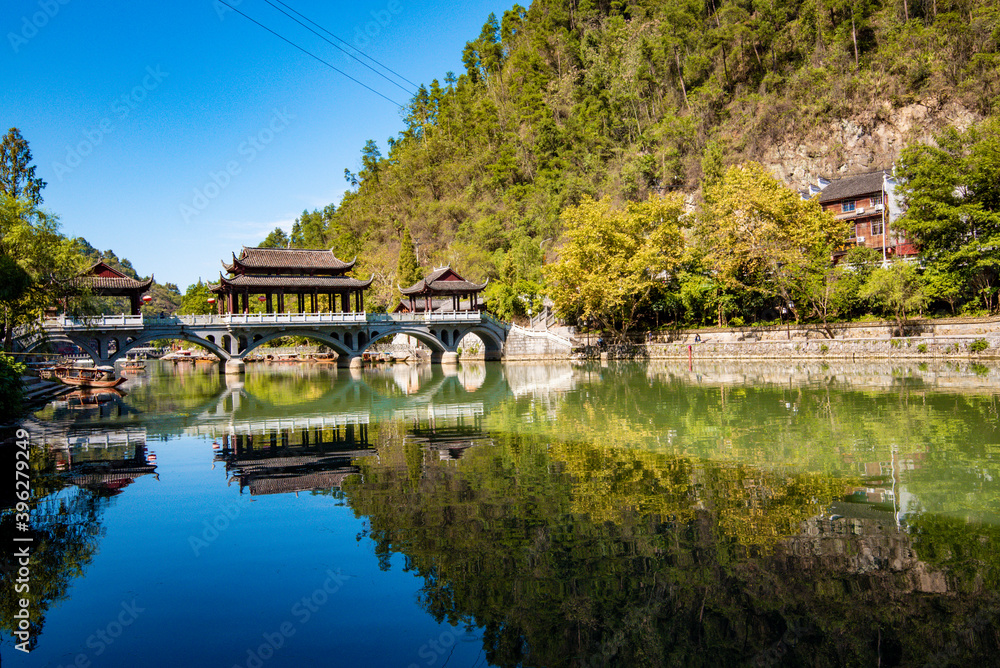 the river, the boat, stone bridge and the old houses at ancient phoenix town in the morning at Hunan, China. the river, the boat, stone bridge and the old houses at ancient phoenix town in the morning at Hunan, China.
