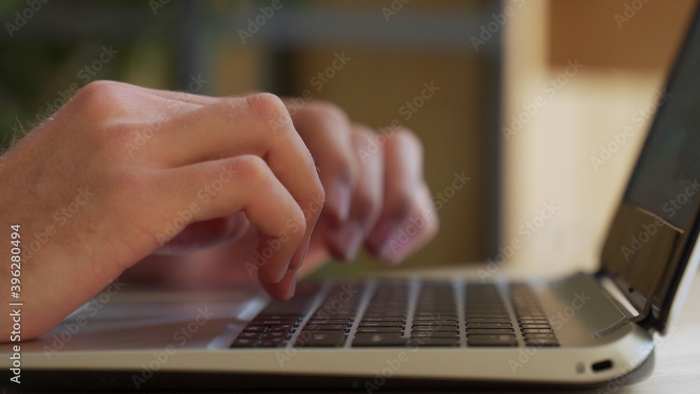 Close up shot of male hands typing on laptop while sitting at office desk indoors. Man fingers tapping and texting on computer keyboard while working in cabinet. Close up shot of male hands typing on laptop while sitting at office desk indoors. Man fingers tapping and texting on computer keyboard while working in cabinet.