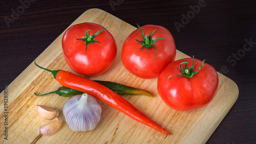 ripe fresh tomato and pepper on a white background