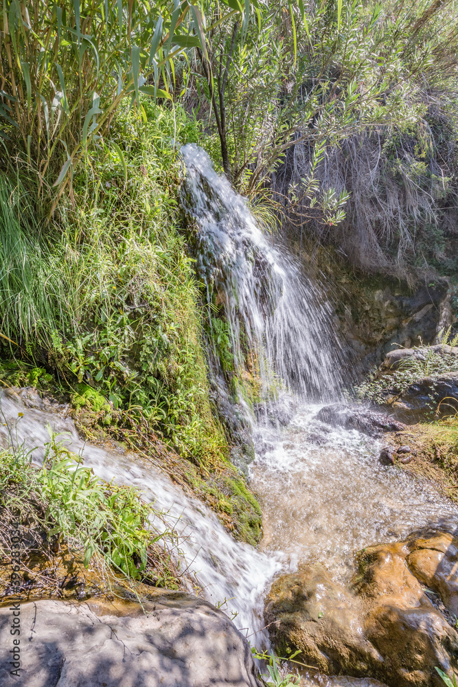 Fototapeta premium Park of waterfalls with green clean water ponds (Toll del Baladre, Las Fuentes del Algar / Algar fountains, Callosa de Ensarria) Alicante province, Spain.