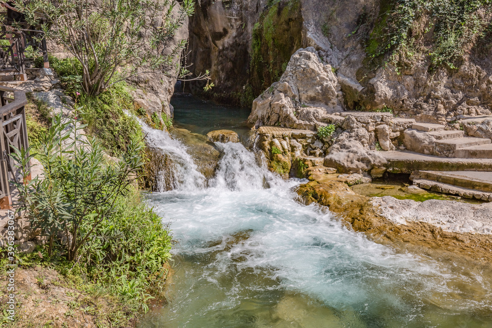 Park of waterfalls with green clean water ponds (Toll del Baladre, Las Fuentes del Algar / Algar fountains, Callosa de Ensarria) Alicante province, Spain.