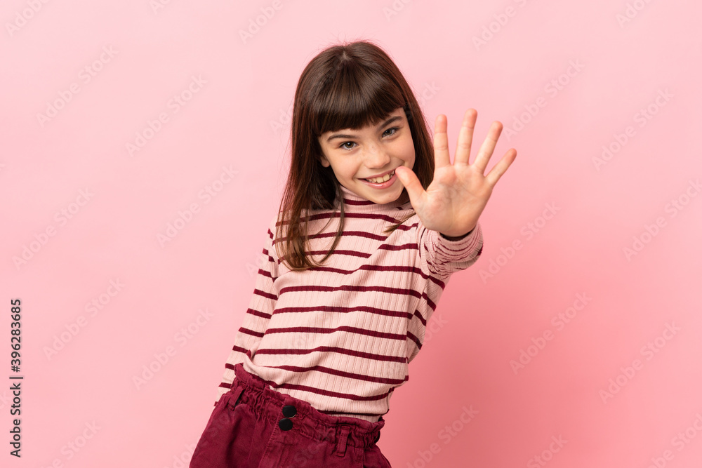 Little girl isolated on pink background counting five with fingers Little girl isolated on pink background counting five with fingers