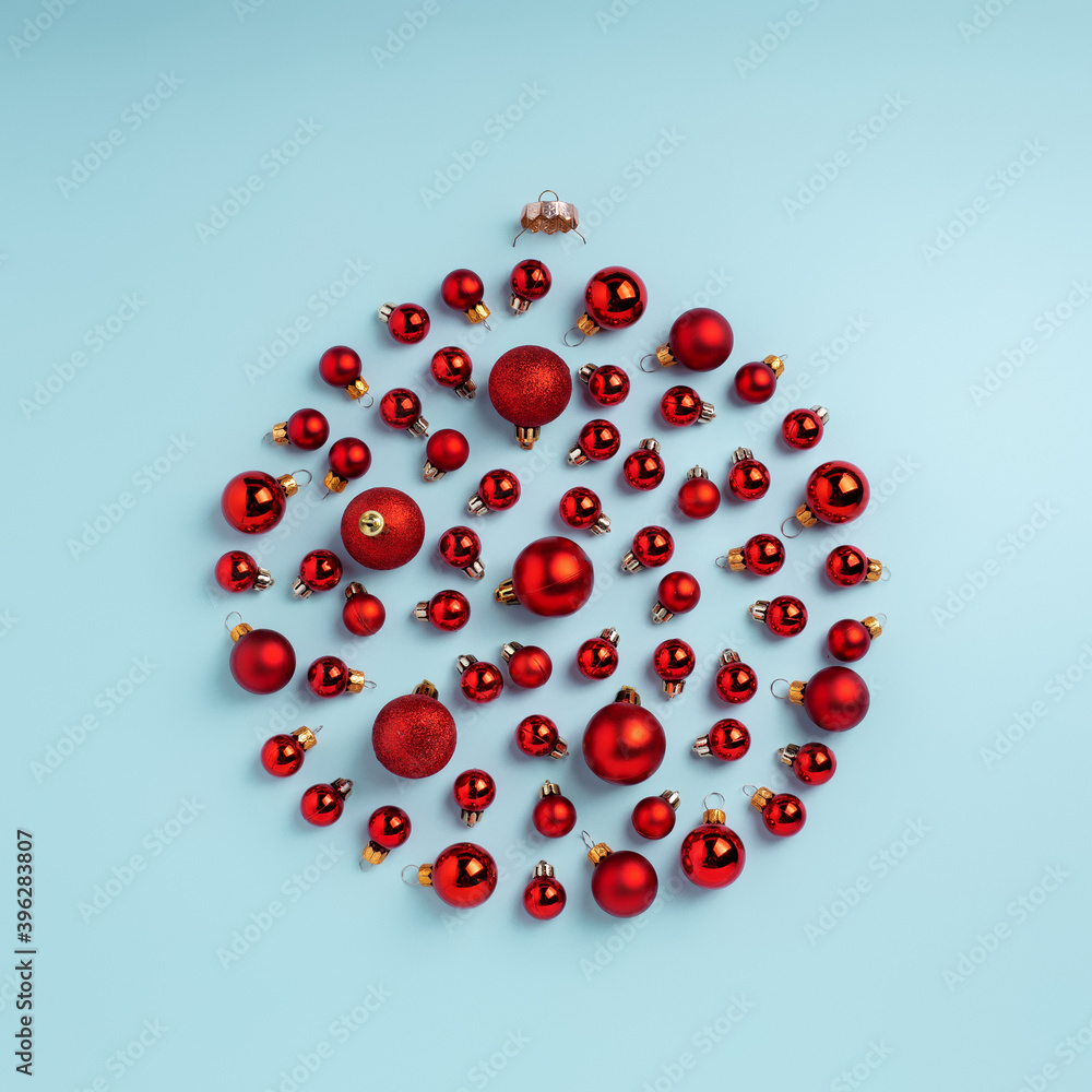 Christmas objects laid out in the shape of a Christmas bauble on pastel blue background. Minimal New year decoration concept. Flat lay, top view. Christmas objects laid out in the shape of a Christmas bauble on pastel blue background. Minimal New year decoration concept. Flat lay, top view.
