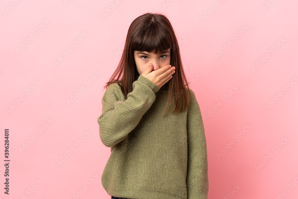 Little girl isolated on pink background covering mouth with hand Little girl isolated on pink background covering mouth with hand