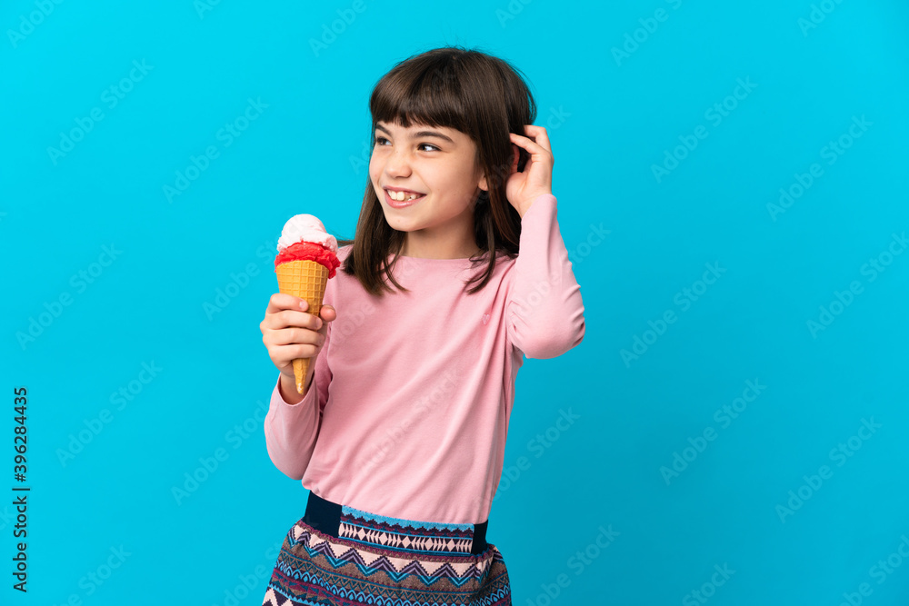 Little girl with a cornet ice cream isolated on blue background having doubts Little girl with a cornet ice cream isolated on blue background having doubts