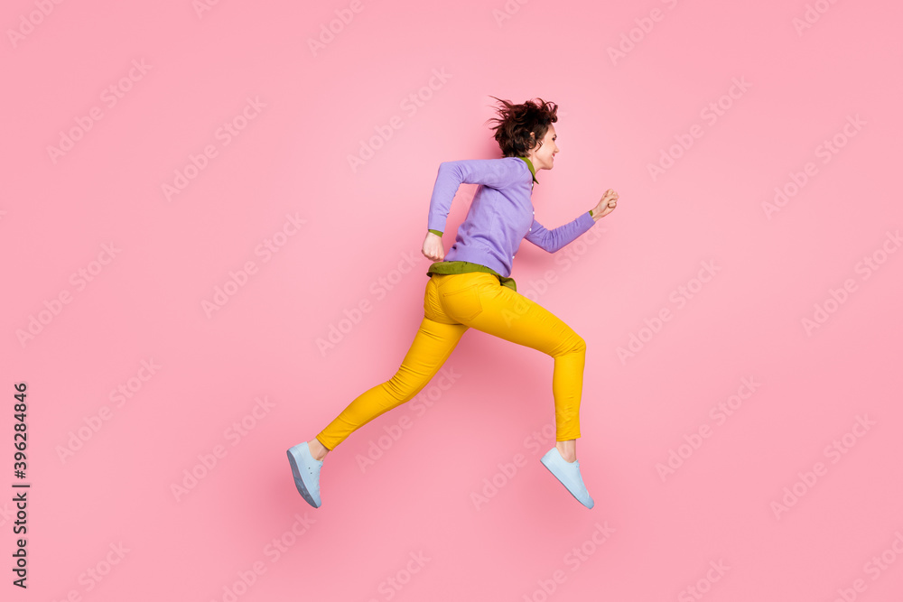 Full length profile side photo of girl jump run fast discounts wear violet gumshoes isolated pink color background Full length profile side photo of girl jump run fast discounts wear violet gumshoes isolated pink color background